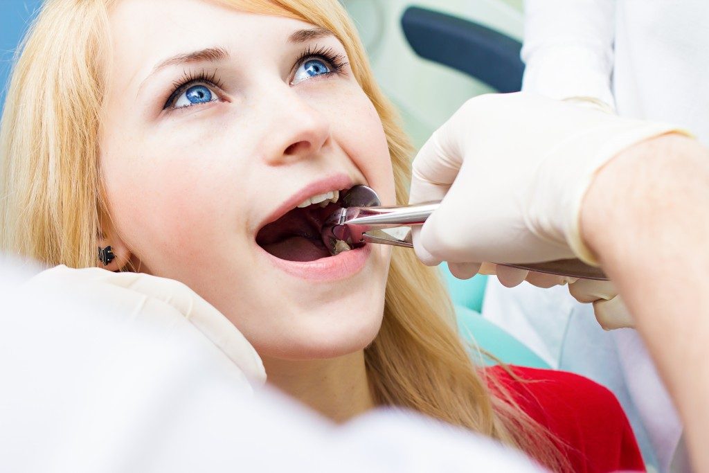 Dentist examining patient's teeth