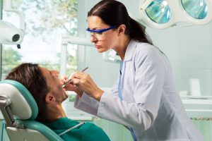 a dentist checking on a patient
