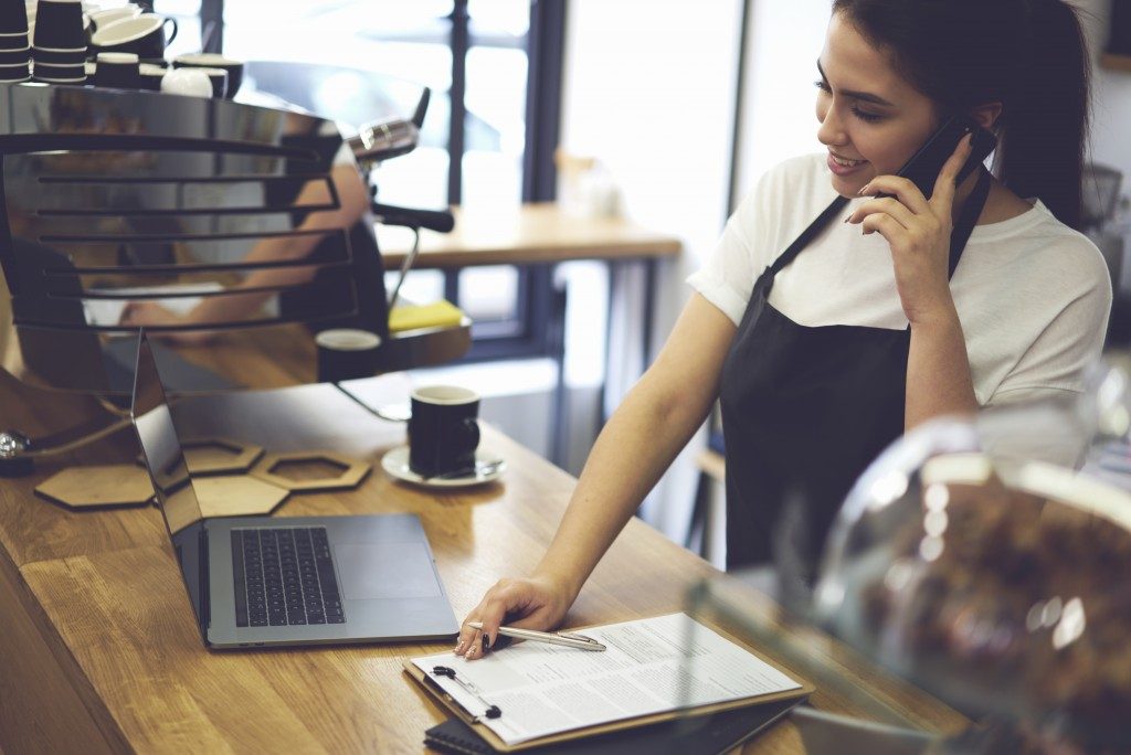 a coffee shop owner making some calls