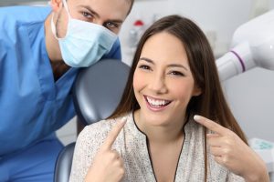 Dentist with patient smiling