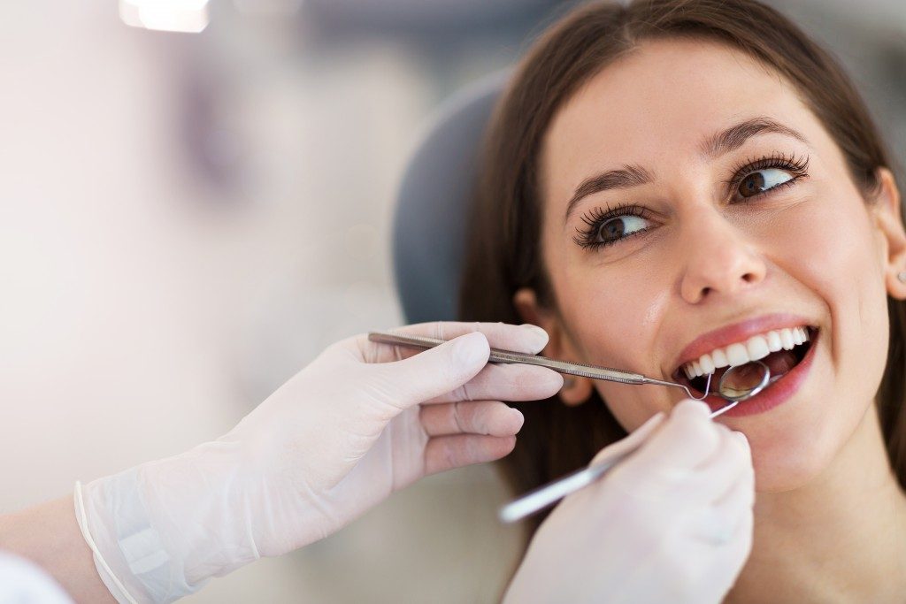 Woman smiling during her dental checkup