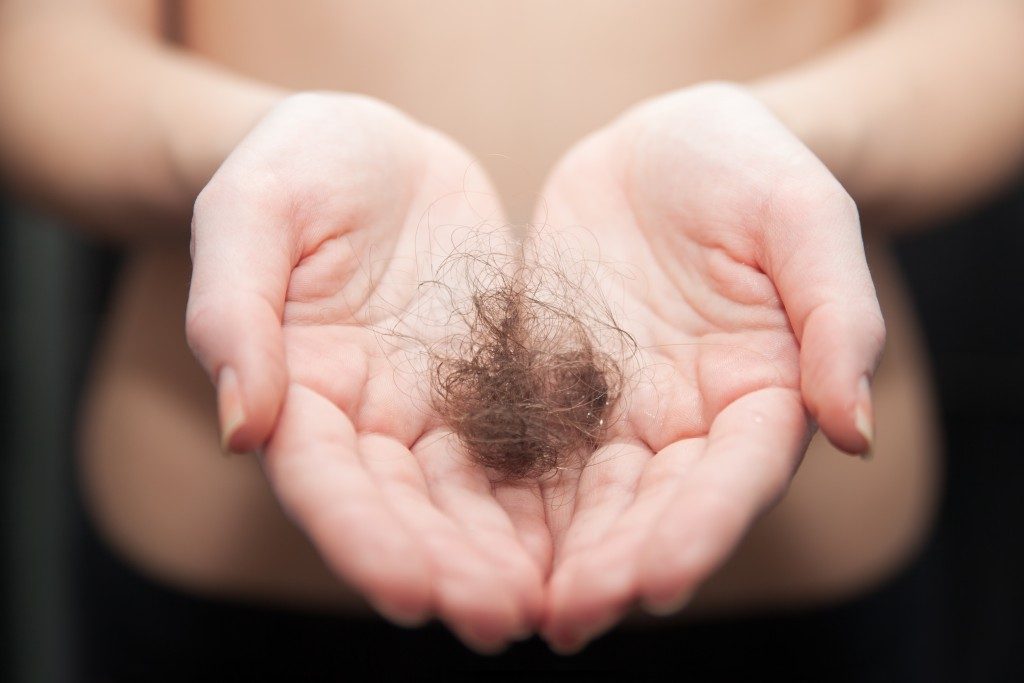 Woman holding a bunch of hair
