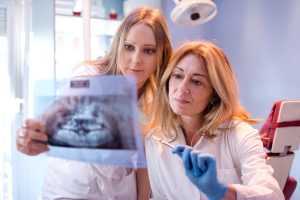 Dentists looking an x-ray of teeth