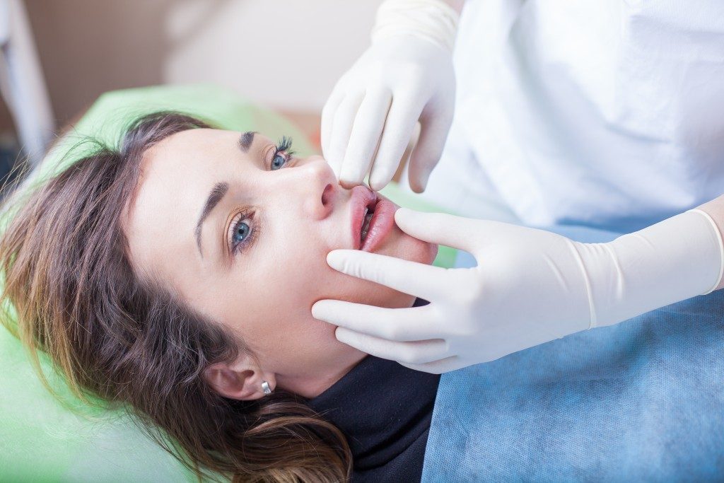 a woman undergoing lip filler procedure