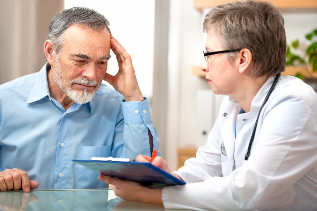 Elderly patient with dementia next to a doctor