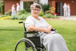 Disabled old woman at the garden