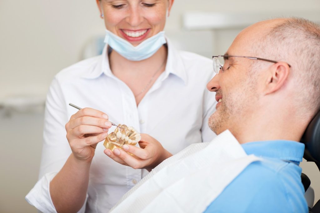 Dentist explaining implant process