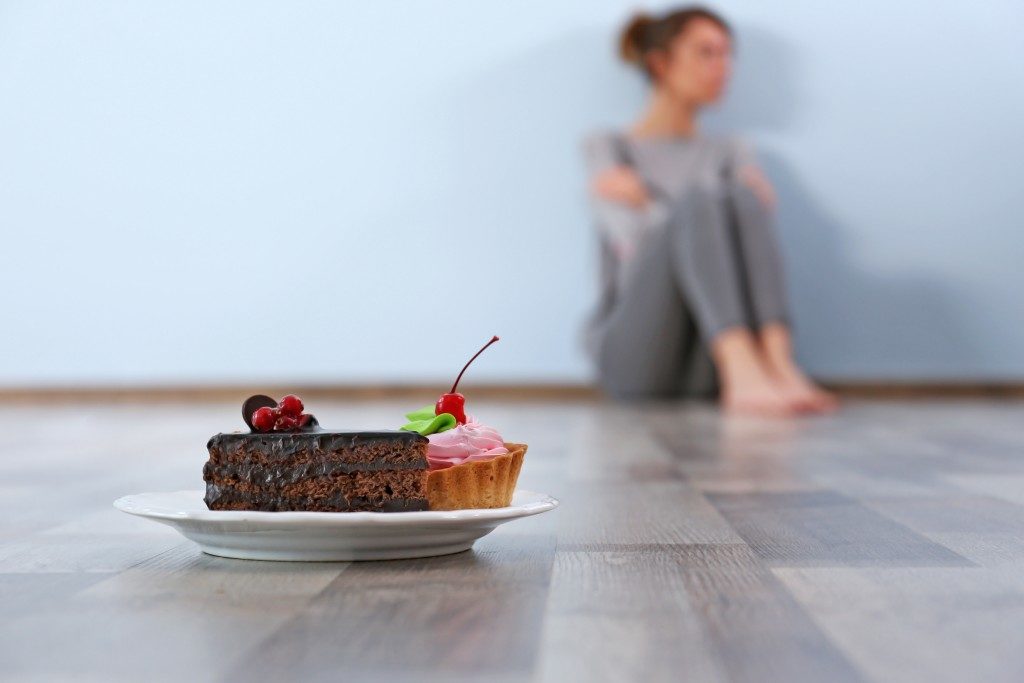 Dessert in a plate with woman behind