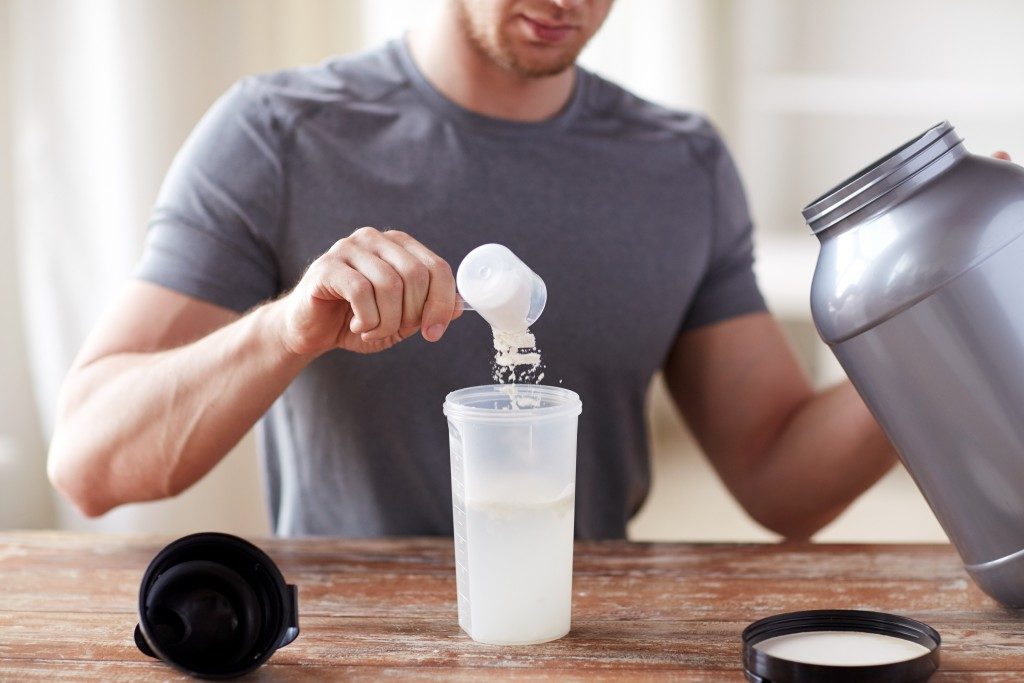 man preparing whey protein drink
