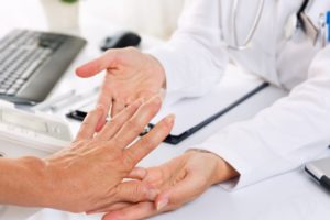 doctor examining patient with rheumatism 