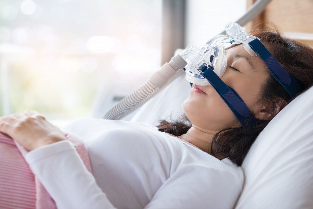 Woman using a breathing machine while sleeping