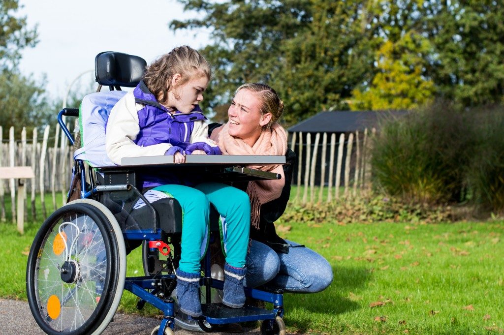 mother talking with her disabled daughter