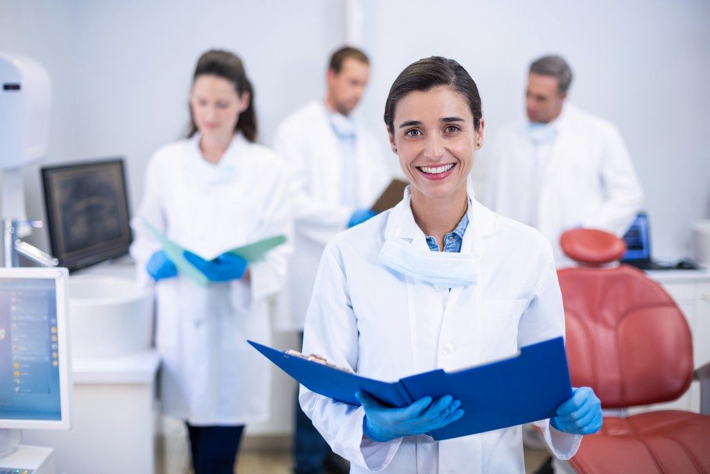 Dentists holding a file in a dental clinic