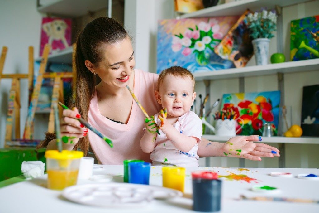 mother and child enjoying painting together