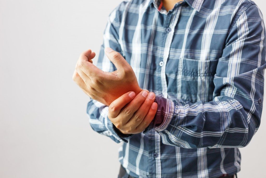 Man feeling joint pain on his wrist