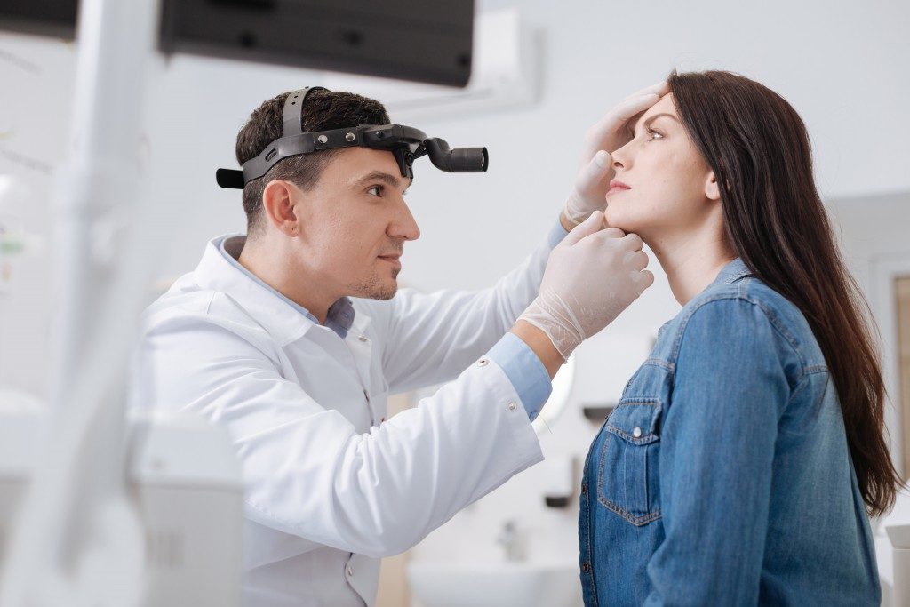 ENT doctor checking the nose of a patient