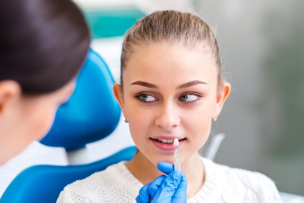 Woman dental check up comparing teeth color