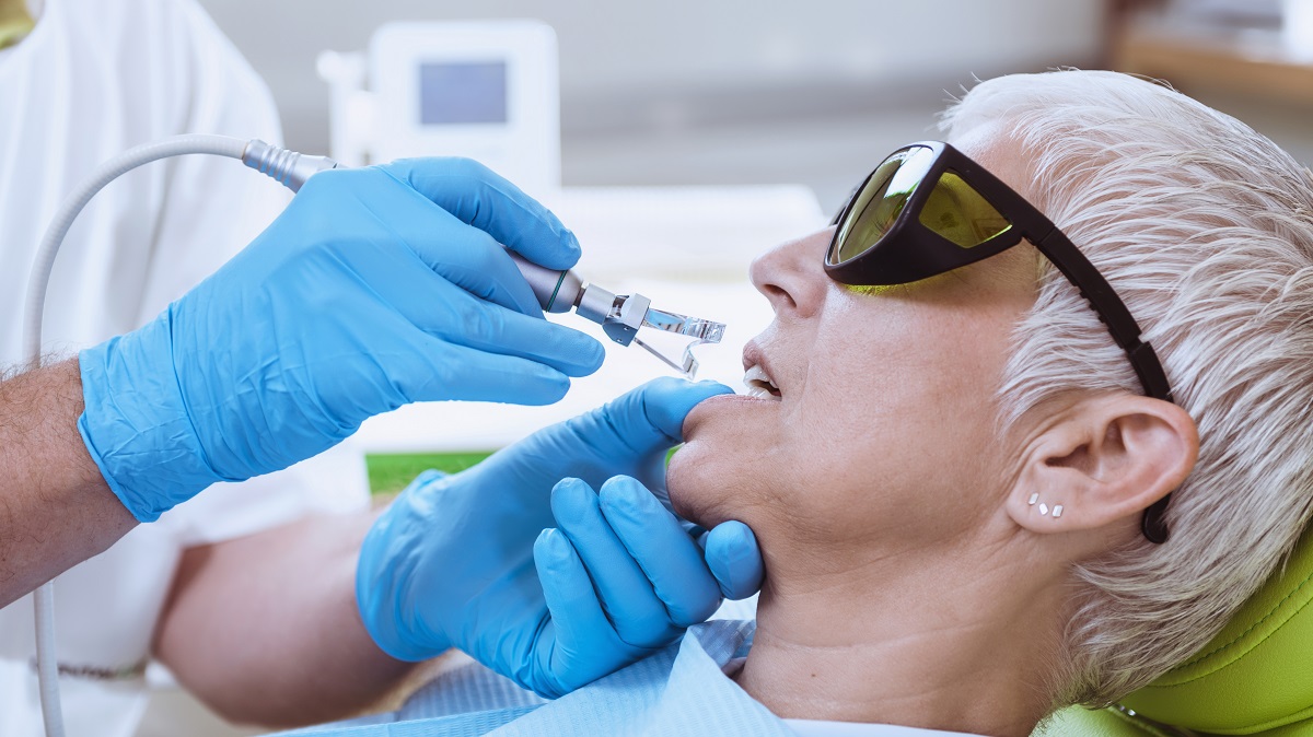 Laser Teeth Whitening Procedure. Senior Female Patient Going Thr