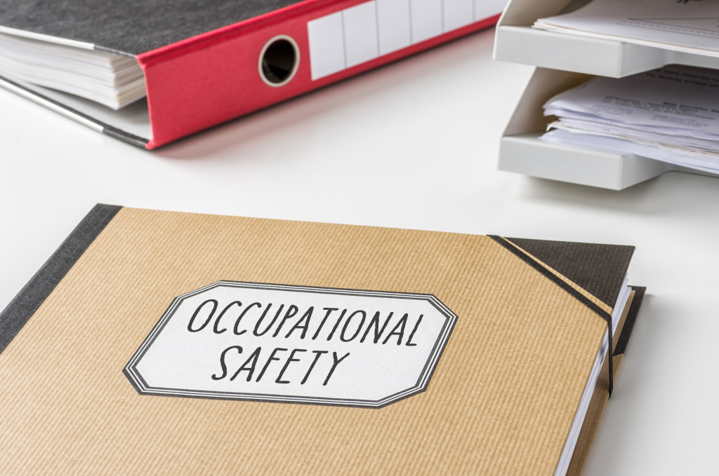 a folder labeled occupational safety with documents inside