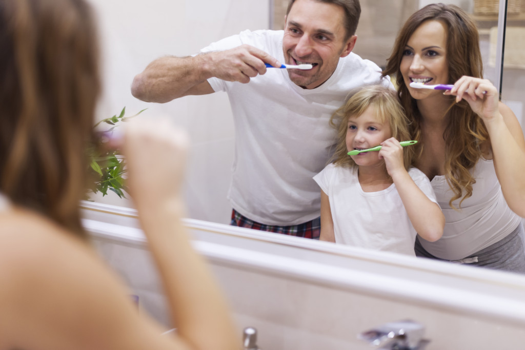 family brushing their teeth together