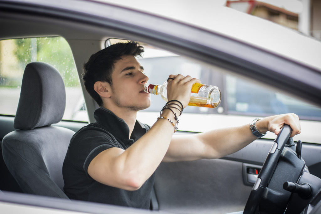 An alcoholic drinking while driving