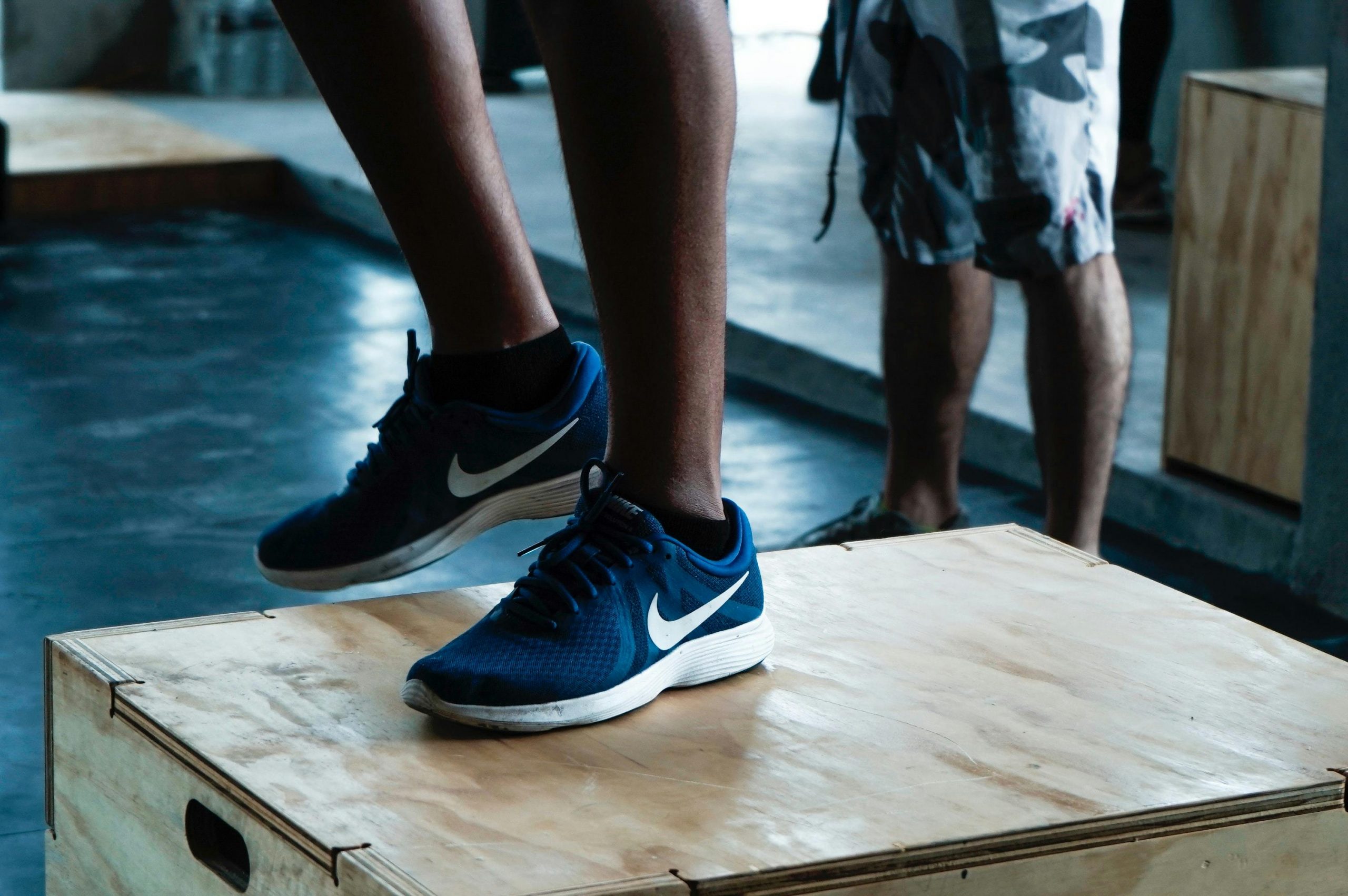 close-up of a foot in a running shoe on a wooden step